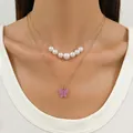 Double-layered gold necklace featuring white pearls and a lavender butterfly pendant - KC Gold-Light Pink Butterfly