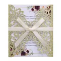 Detail of laser cut gold glitter invitation with cream ribbon bow and floral card - Light Gold Color
