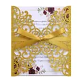 Detail of laser-cut glitter wedding invitation with golden ribbon and floral inner card - Dark Gold