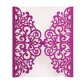 Macro detail of laser cut glitter cardstock invitation with purple scroll patterns - Bright Purple