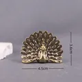Macro detail of vintage brass peacock figurine showing feather texture and dimensions - Peacock Opening Wings
