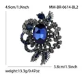 Vintage alloy flower brooch featuring an oval blue faceted gemstone and grey rhinestones - Gunmetal Blue