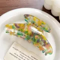 Large colorful acetate hair claw with vibrant marble texture and serrated grip - Metallic Green