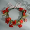 Floral headband featuring red faux flowers, green leaves and a pink organza ribbon bow - Red