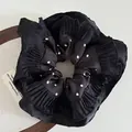 Polka dot satin scrunchie in black with layered ruffles and elegant pleated edges - Black