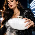 Elegant white marble acrylic clutch bag with a gold metal clasp held by a model - White