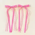 Detail of pink lace ribbon bow hair clips with satin fabric and layered streamers - Rose Red