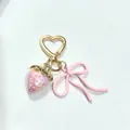 Pink pearlescent strawberry keychain with heart clasp and bow charm accessory - Solid Pink Strawberry Bow (KC Gold Heart Hook)