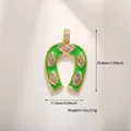 Detail of horseshoe pendant with pink evil eye and green enamel inlay in gold plating - Green Enamel Evil Eye Horseshoe