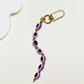 Bohemian style keychain with purple resin evil eye oval beads and golden lobster clasp - Purple Oval Beads