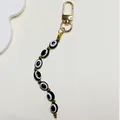 Vintage style Evil Eye keychain with black and white beads and gold-tone metal hardware - Black Oval Beads