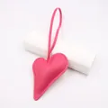 Detail of pink faux leather heart charm with lychee texture and matching stitching - Rose Red