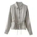 Macro view of silver-grey glossy satin shirt texture with drawstring waist detail - XS / Slate Gray