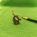 Detail of vintage brass leopard miniature figurine with antique finish on green fabric - Descending Tiger Style