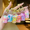 Luminous drift bottle keychain with liquid, macaron beads, and golden bell details - Luminous Snowflake (Gold Hardware) / Lobster Clasp Style / Multicolor