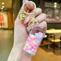 Pink liquid bottle keychain with bubble beads, snowflakes and golden bell charm - Luminous Snowflake (Gold Hardware) / Lobster Clasp Style / Pink
