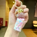 Pink drifting bottle keychain with golden bell and liquid glitter for school bags - Luminous Snowflake (Gold Hardware) / Lobster Clasp Style / White