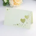 Detail of laser-cut heart hollow design on pearlescent card for wedding table seating - Emerald Green