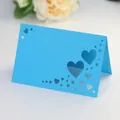 Macro view of laser-cut heart pattern on a sky blue stand-up wedding place card - Sky Blue