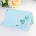 Detail of light blue pearlescent place card with laser cut heart patterns for weddings - Pearl Pale Blue