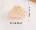 Detail view of shell-shaped acetate hair clip with dimensions 5.9cm by 4.2cm, set of 25 - Original Color Of Seashell