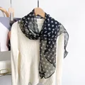 Black mulberry silk neck scarf with white polka dots tied on a white knit sweater - Black Polka Dot