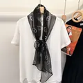 Polka dot black 100% silk skinny scarf tied on a white shirt collar detail - Black With White Circles
