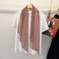 Elegant white short-sleeve shirt paired with a classic brown checkered silk scarf - Carmine Red Plaid