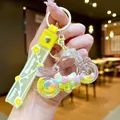 Porte-clés moto créatif avec perles macarons et dragonne jaune Happy Moments - Moto En Corde Florale Jaune Et Flocon De Neige Lumineux