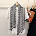 Long silk scarf with black and white geometric patterns on a white button-up shirt - Grey Tone Patterns