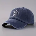 Classic washed denim blue baseball cap with white sea turtle embroidery and curved brim - One Size / Navy Blue