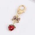 Gold-plated keychain with red enamel strawberry pendant and purple ribbon charm - Transparent Bow Half Strawberry