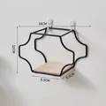 Minimalist black iron wall shelf with light wood base and wavy geometric design - Small / Black