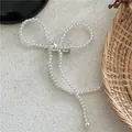 Detail of white faux pearl bow hair clip with ribbons and a silver metal duckbill base - Artificial Pearl Bowknot Style (D6.4/J52-B58) / White