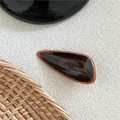 Detail of amber acetate hair clip with gold France Handmade lettering on it - Amber Pattern Triangle Hair Clip (J49-B202) / Dark Coffee