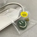 Detailed view of cute green smiley badge and heart accessory in clear zipper bag - Dark Green Smiley Face Badge Set (J5-B65) / Dark Green