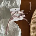 Pink satin bow hair clips with long ribbons on display card for elegant styling - Pair of Pink Satin Bow Clips (52-B82) / Pink