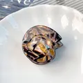 Elegant tortoiseshell cellulose acetate hair claw clip with gold shell spiral detail - Amber