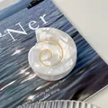 Conch shaped white acetate hair claw clip with golden spiral wire and pearlescent finish - Pearly White