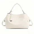 Detailed view of cream-white handbag with silver D-ring hardware and smooth leather texture - White