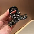 Macro detail of large hair claw clip with faceted dark grey crystal bead embellishments - Full Strawberry Bead Inlaid Style / Black