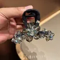 Detail of elegant black fabric hair claw clip featuring sparkling crystal flower decor - Crystal Flower Style / Black