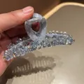 Detail shot of light blue fabric hair claw clip with sparkling crystal beads decor - Heart-Shaped Rhinestone Satin Style / Light Blue