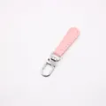 Detailed view of a pink leather zipper pull with precise stitching and a silver metal clasp - Pink