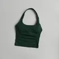 Detail showing forest green halter neck sports bra with ribbed texture and square neck - Forest Green