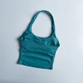 Close-up of teal halter yoga vest showing ribbed texture and ruched chest detail - Teal