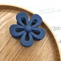 Matte navy blue flower hair claw clip for girls in a round wooden jewelry tray - Hollow Navy Blue