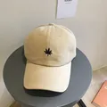 Beige cotton baseball cap with black embroidered leaf pattern for casual outdoor wear - Maple Leaf - Off-white