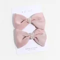 Set of two pink silk bow hair clips with white faux pearl accents on display card - Small Pearl Lotus Pink