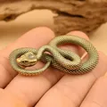 Macro shot of detailed scale texture on a brass cobra snake figurine held in hand - Large Snake